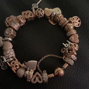 Pandora rose gold bangle with 27 rose pandora charms and 1 safety chain